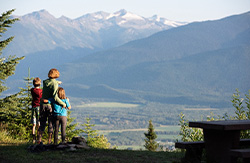 Family at a viewpoint in McBride with forest in background